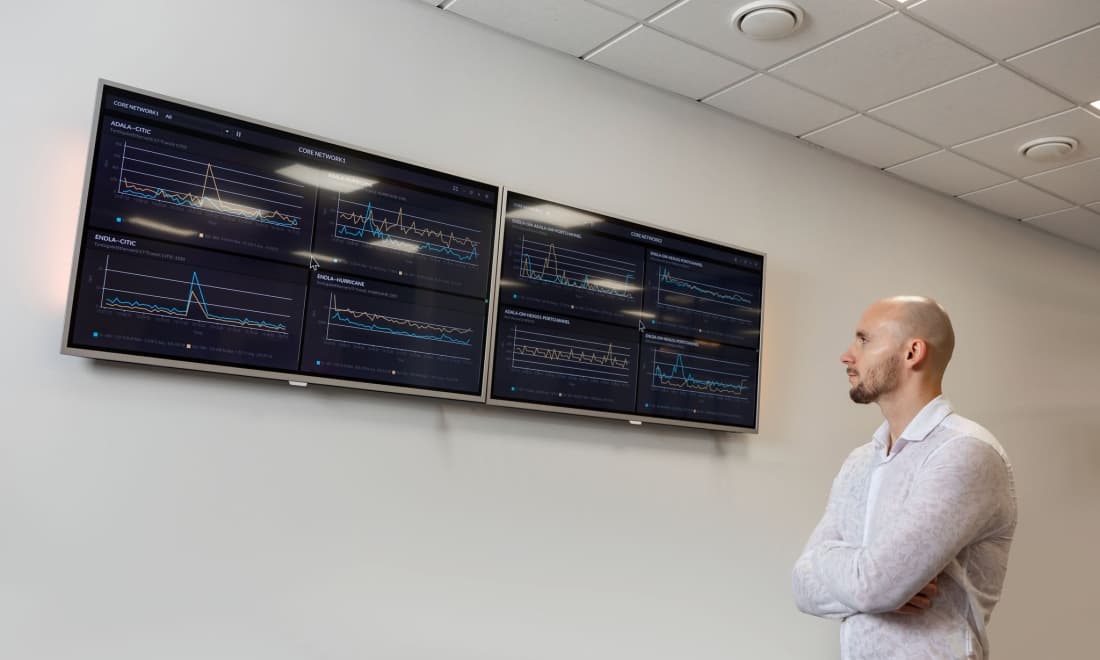 Engineer watching core network traffic dashboards